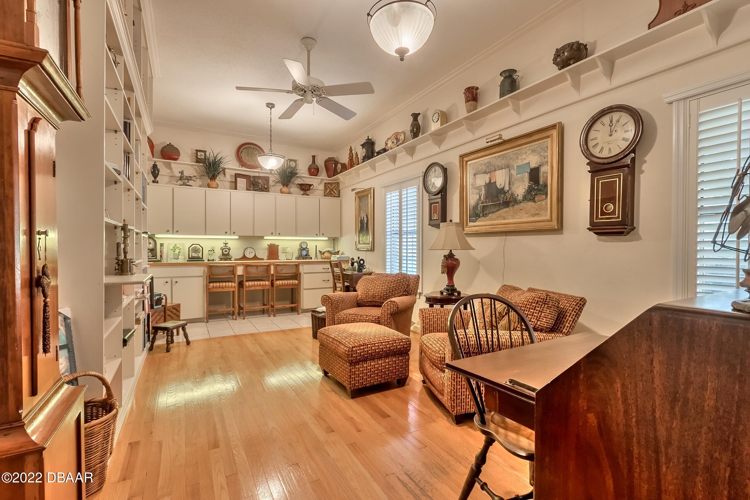 8 Moss Point Drive Ormond Beach, FL 32174 - Photo 27 of 63 a living room with furniture and a clock