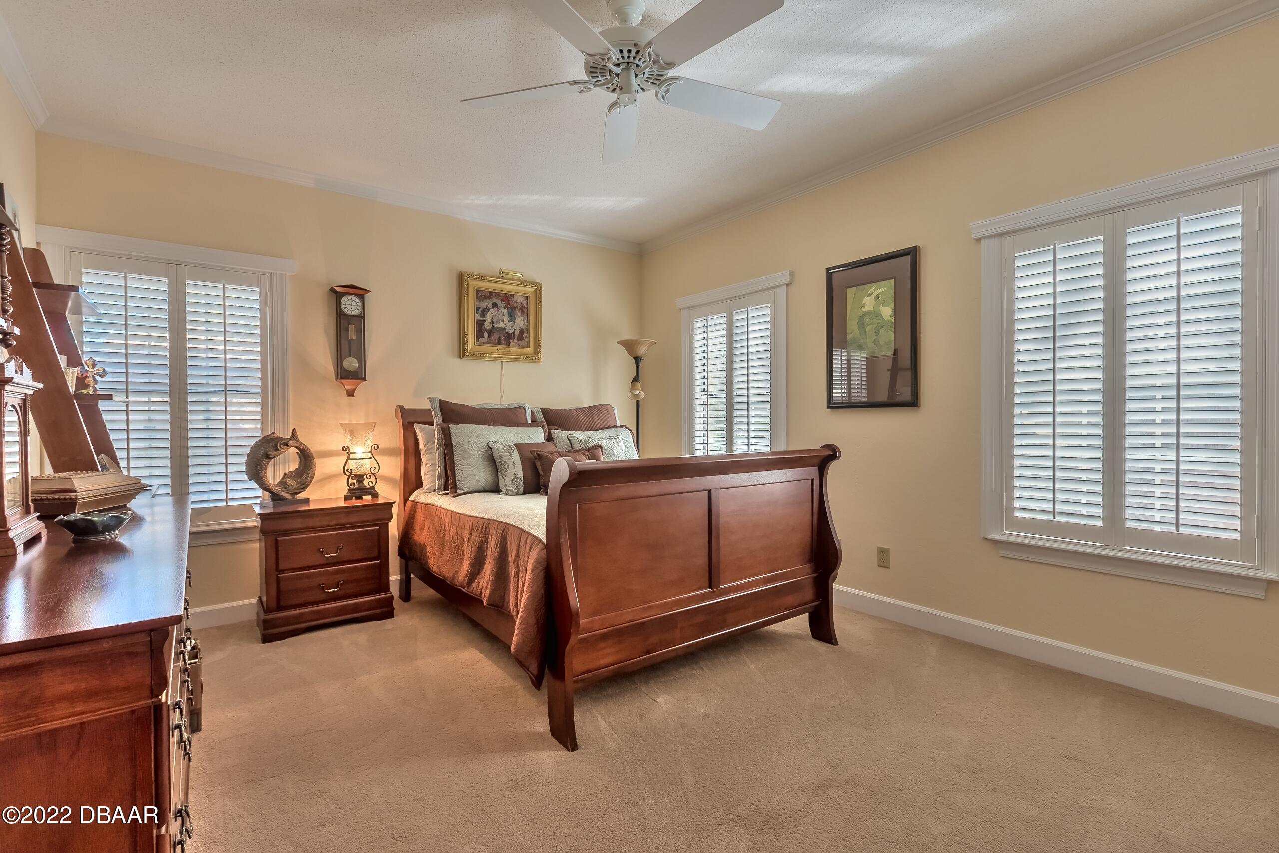 8 Moss Point Drive Ormond Beach, FL 32174 - Photo 32 of 63 a spacious bedroom with a bed and a window