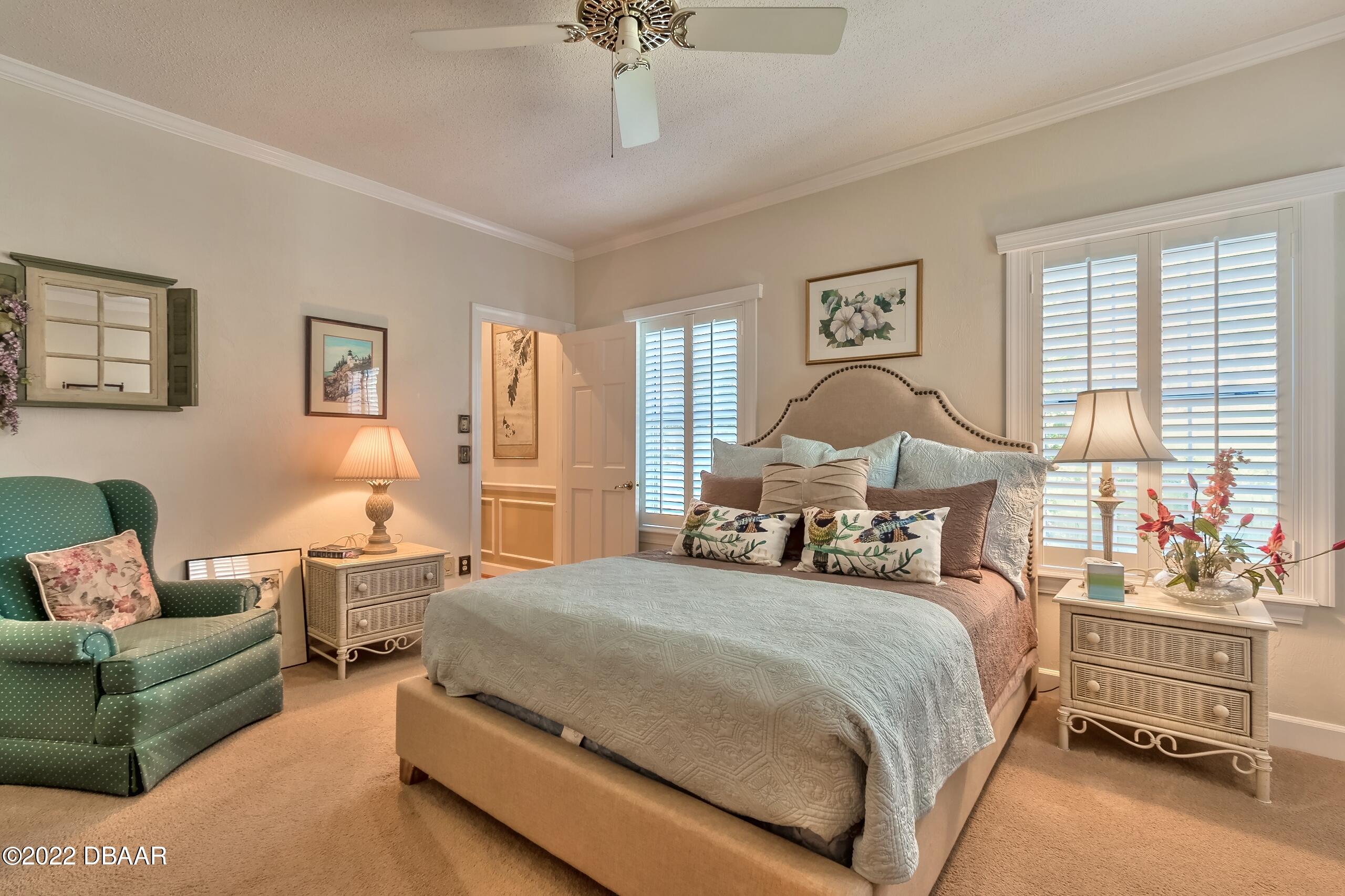 8 Moss Point Drive Ormond Beach, FL 32174 - Photo 34 of 63 a bedroom with a bed and wooden floor