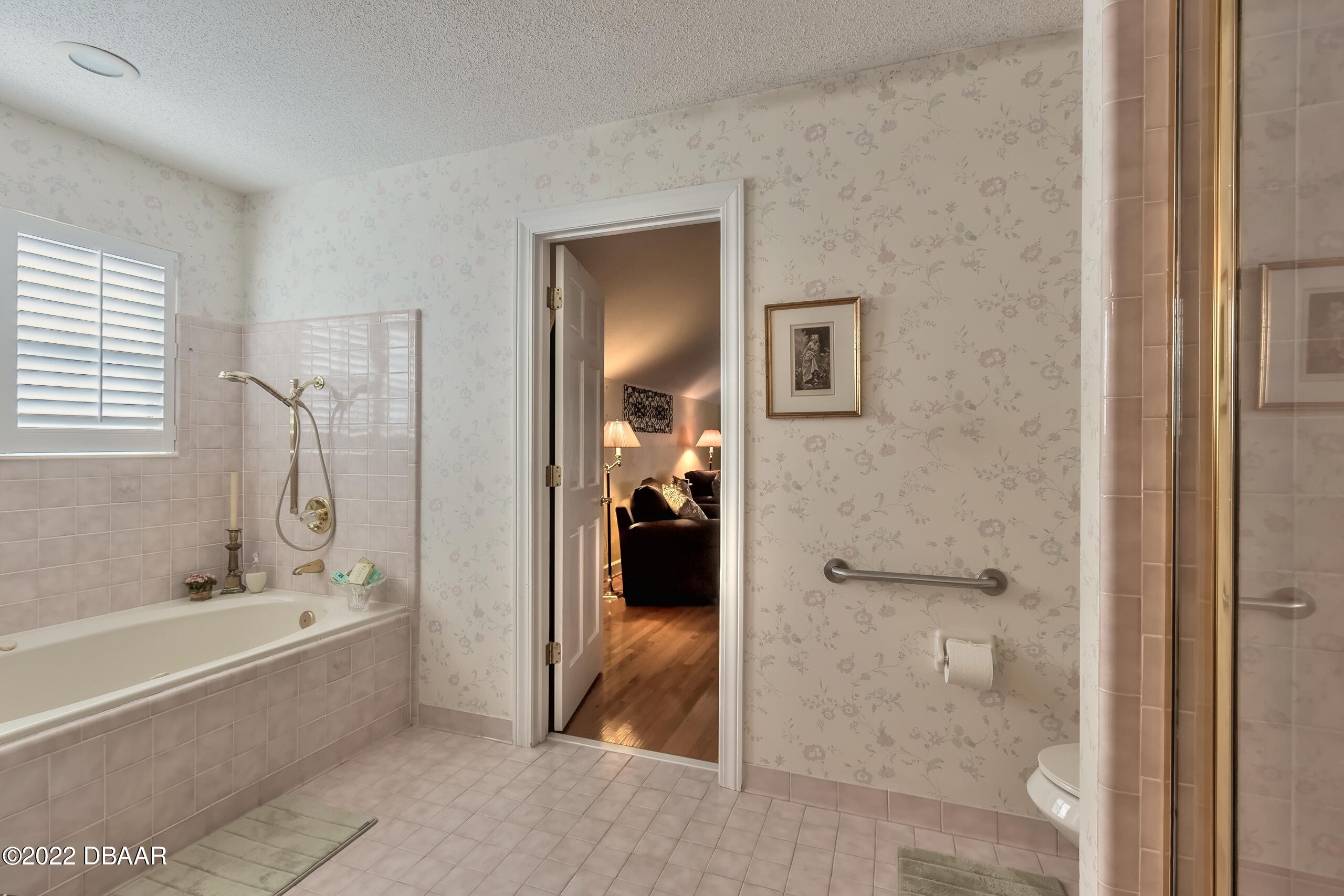 8 Moss Point Drive Ormond Beach, FL 32174 - Photo 39 of 63 a bathroom with a tub shower and a sink