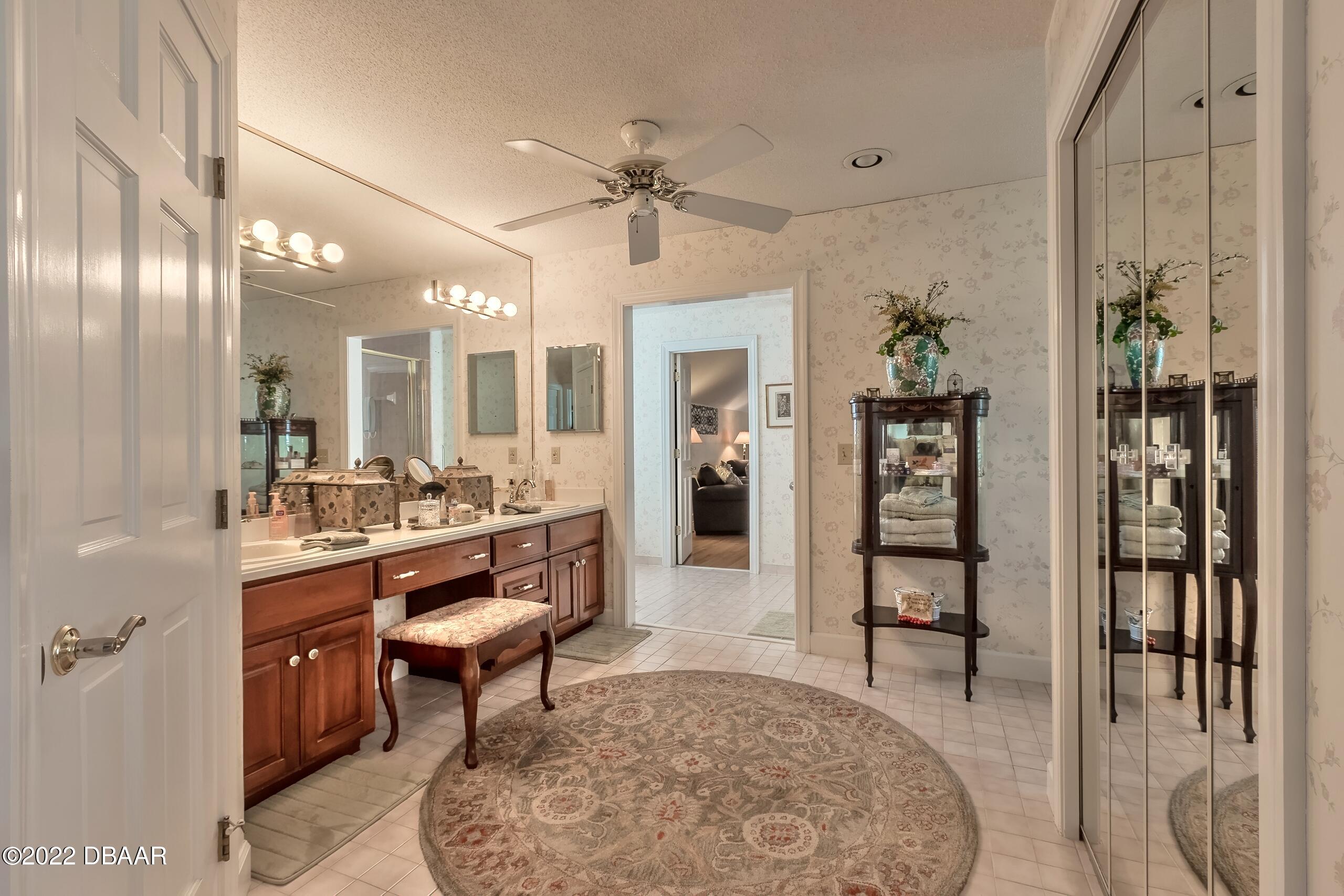 8 Moss Point Drive Ormond Beach, FL 32174 - Photo 42 of 63 a view of a hallway with dining area and chandelier