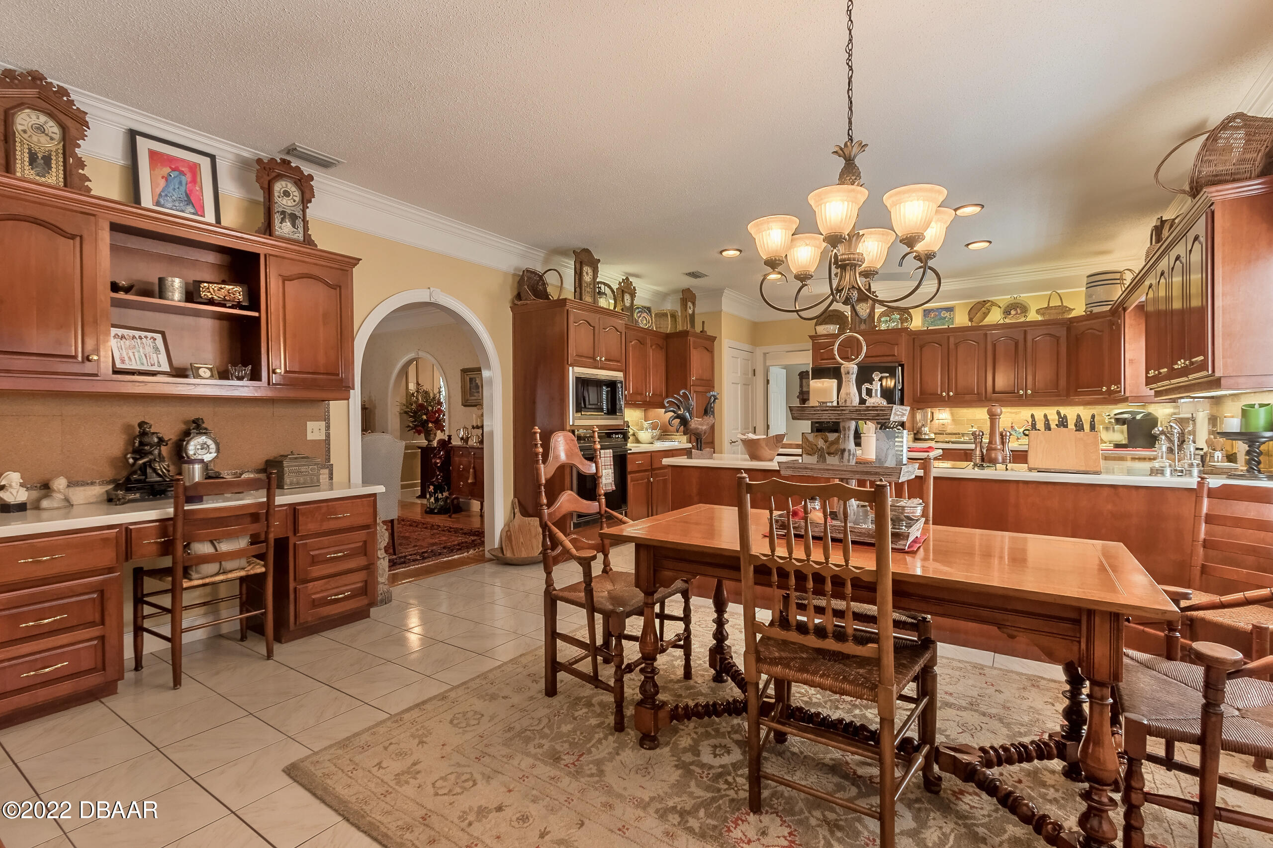 8 Moss Point Drive Ormond Beach, FL 32174 - Photo 49 of 63 a view of a dining room with furniture and chandelier