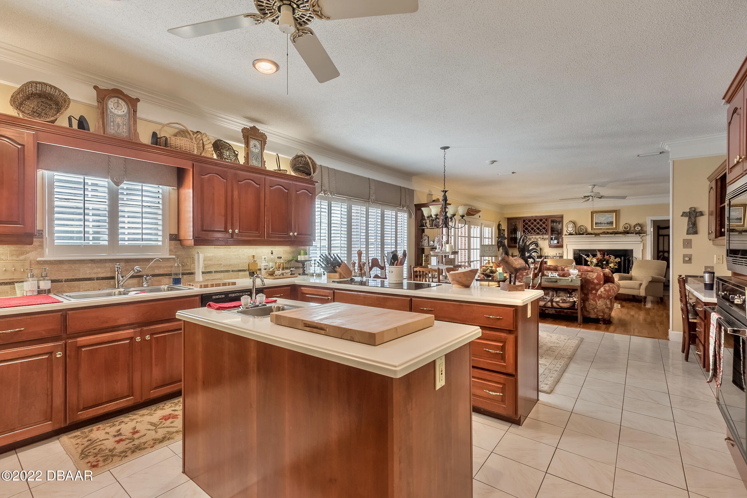 8 Moss Point Drive Ormond Beach, FL 32174 - Photo 52 of 63 a kitchen with lots of counter top space and living room