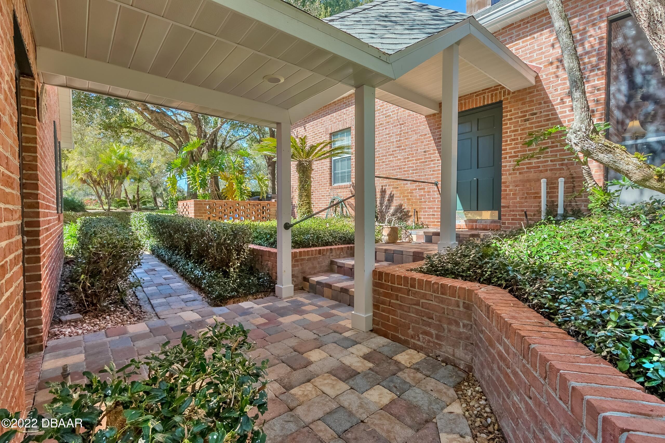 8 Moss Point Drive Ormond Beach, FL 32174 - Photo 58 of 63 a view of a garden with potted plants