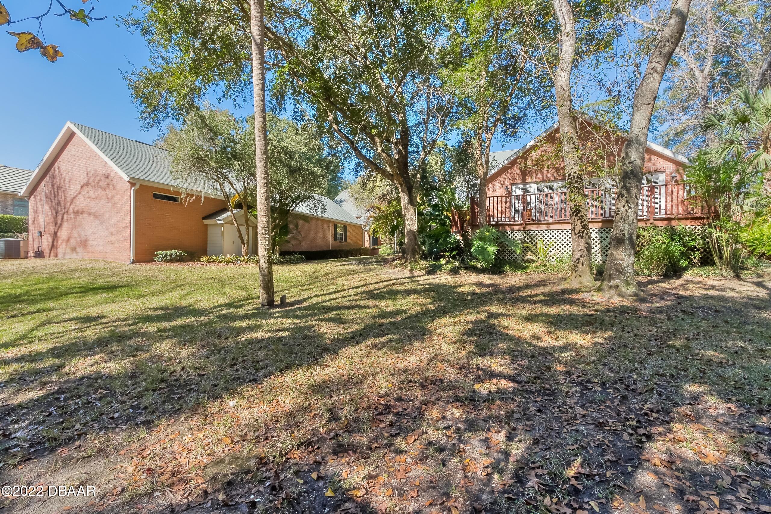 8 Moss Point Drive Ormond Beach, FL 32174 - Photo 60 of 63 a view of a house with backyard and tree