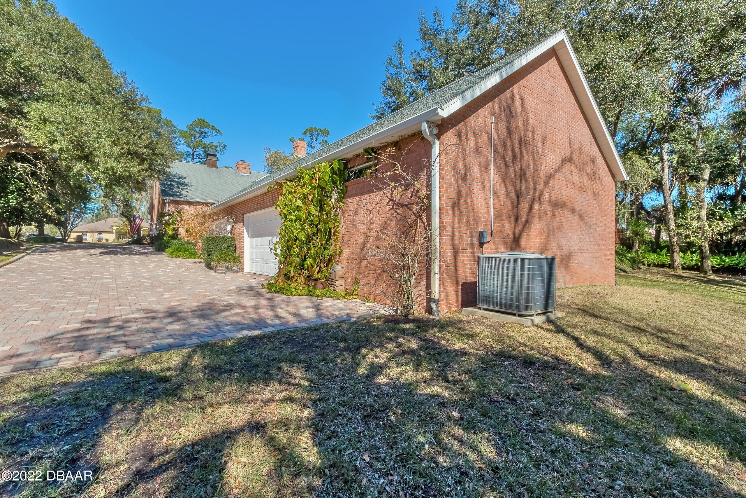 8 Moss Point Drive Ormond Beach, FL 32174 - Photo 63 of 63 a view of backyard with tree