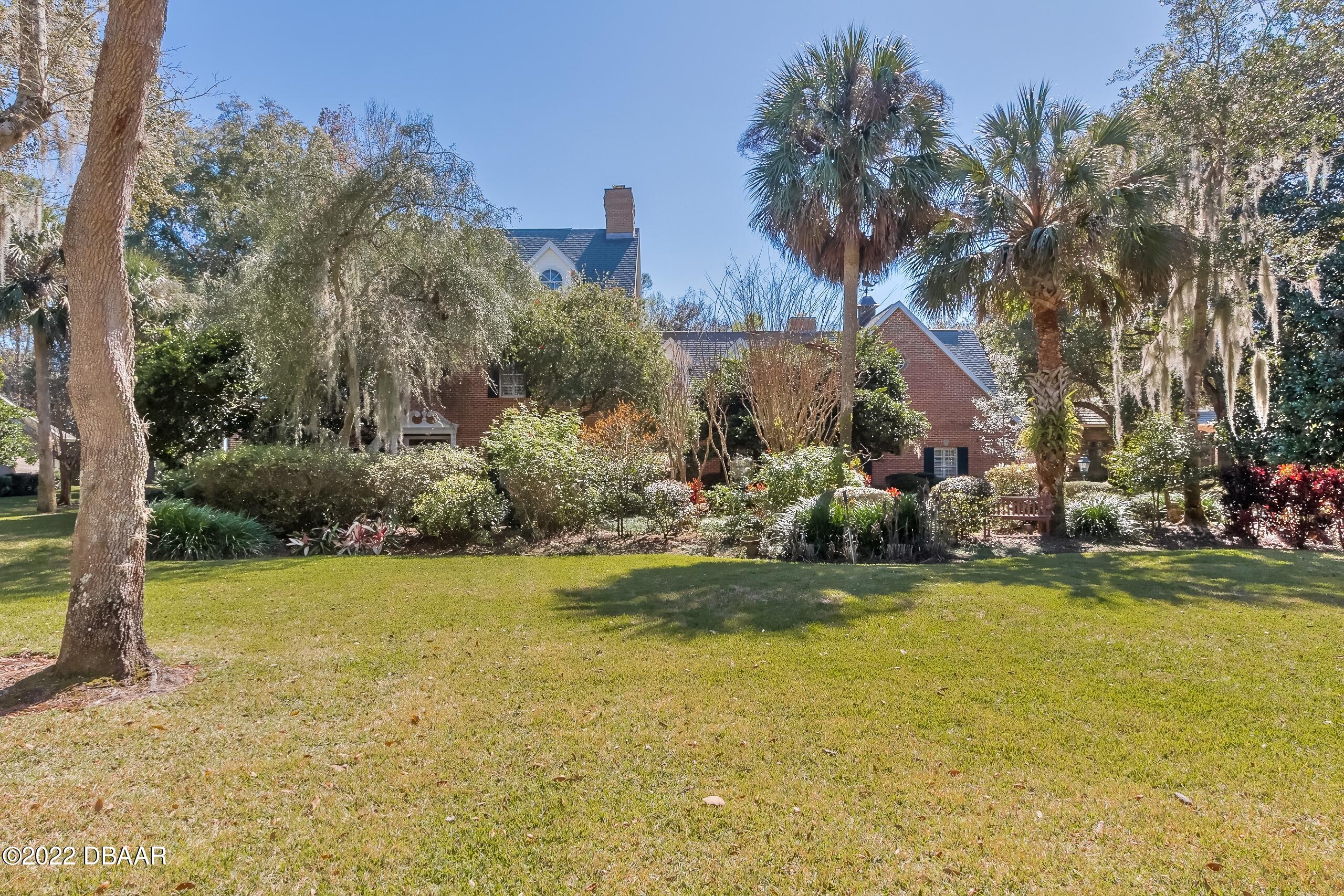 8 Moss Point Drive Ormond Beach, FL 32174 - Photo 8 of 63 a view of a swimming pool with an outdoor space and seating area