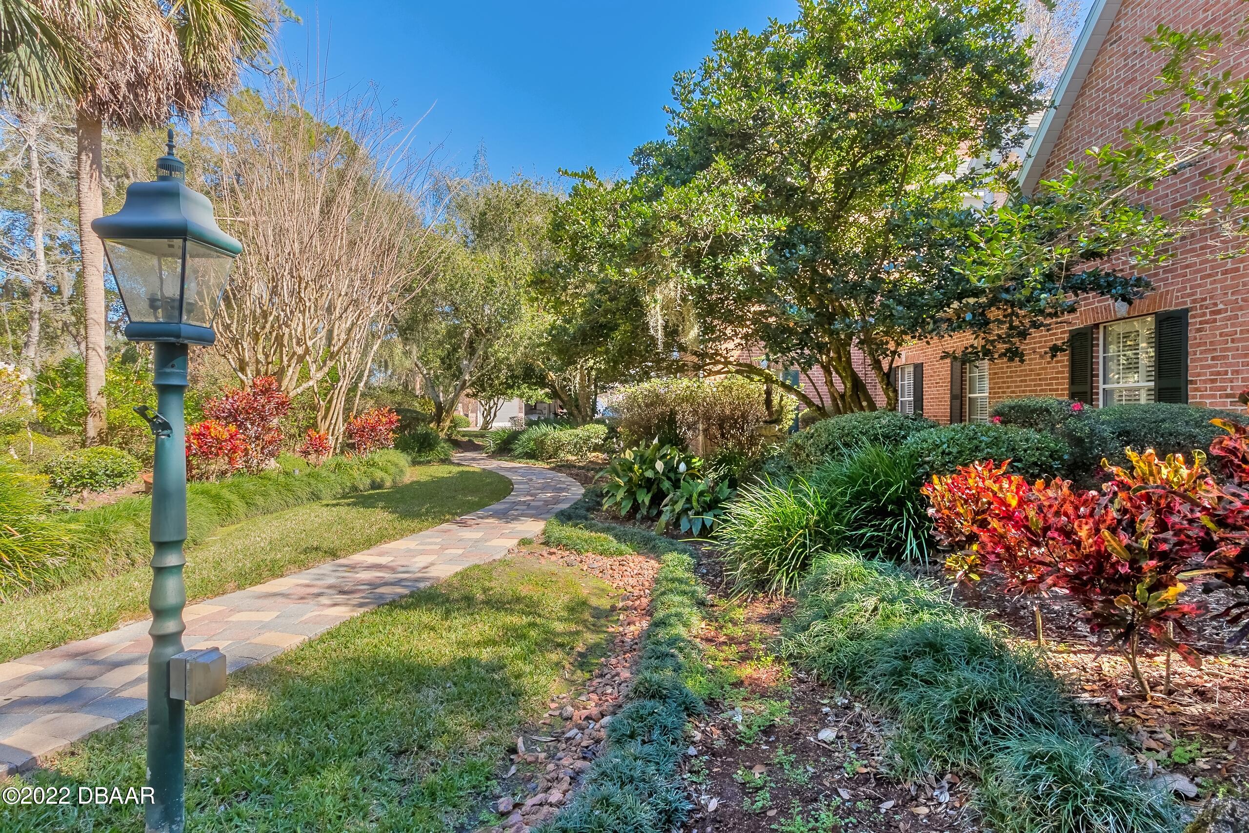 8 Moss Point Drive Ormond Beach, FL 32174 - Photo 10 of 63 a view of a house with a yard