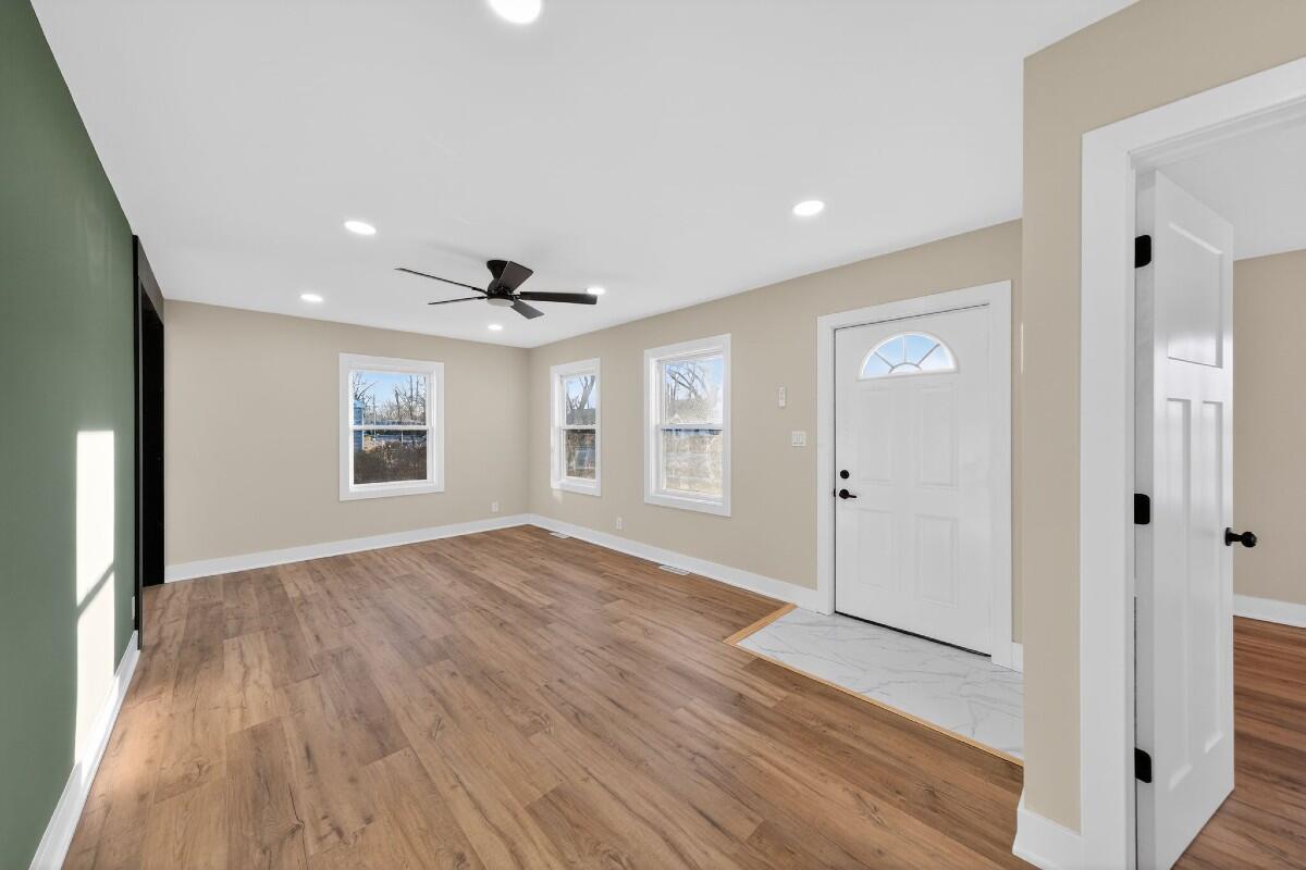 423 Cline Avenue Griffith, IN 46319 - Photo 11 of 33 wooden floor in an empty room with a window