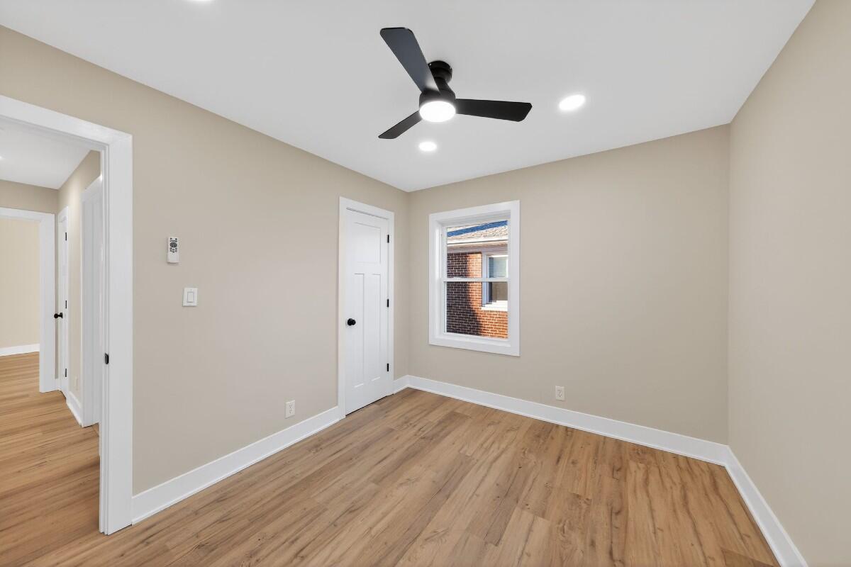423 Cline Avenue Griffith, IN 46319 - Photo 16 of 33 wooden floor in an empty room with a window