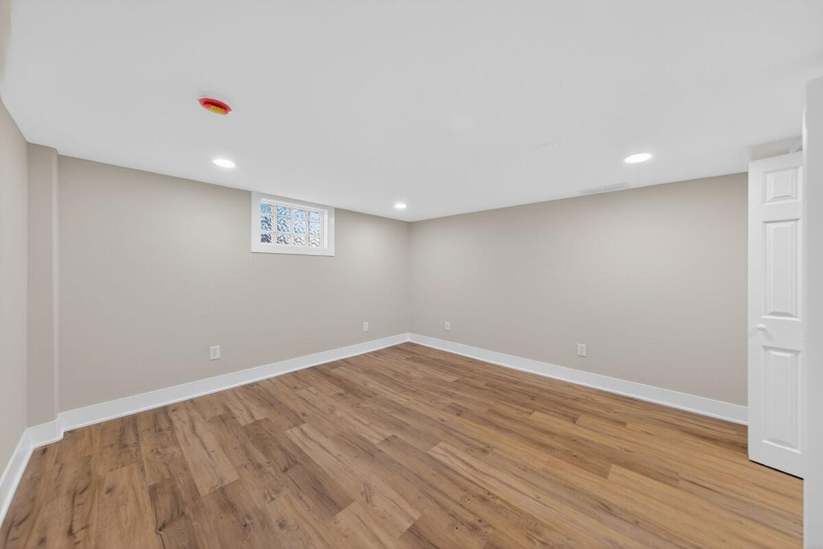 423 Cline Avenue Griffith, IN 46319 - Photo 19 of 33 a view of an empty room with wooden floor and a window