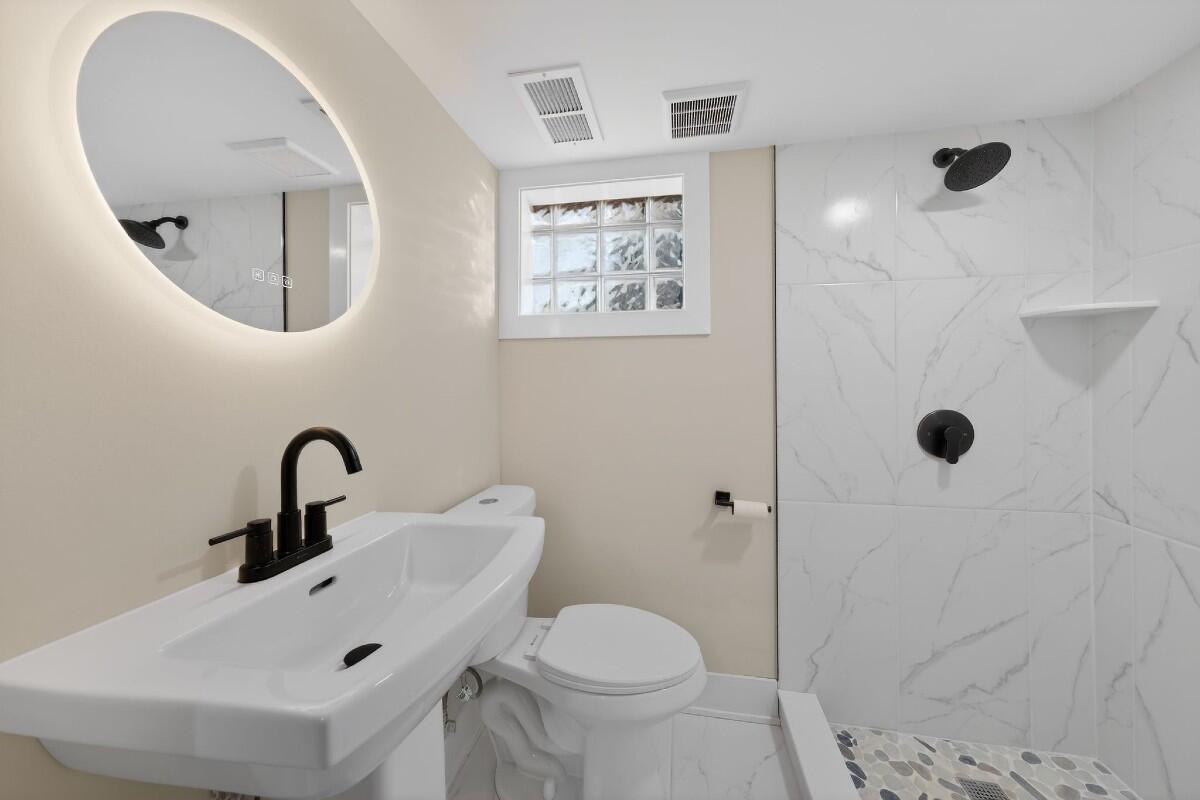 423 Cline Avenue Griffith, IN 46319 - Photo 21 of 33 a bathroom with a sink mirror and toilet