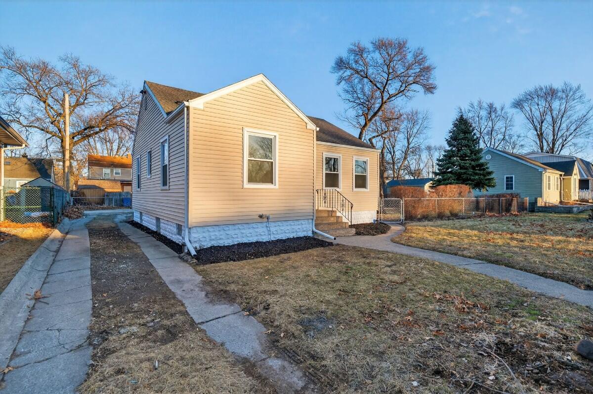 423 Cline Avenue Griffith, IN 46319 - Photo 26 of 33 a view of a white house with a yard