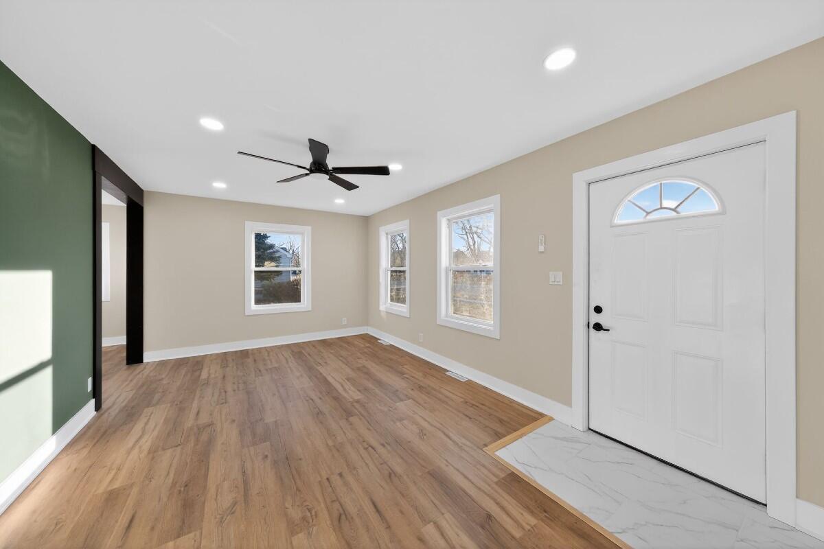 423 Cline Avenue Griffith, IN 46319 - Photo 10 of 33 a view of an empty room with wooden floor and a window