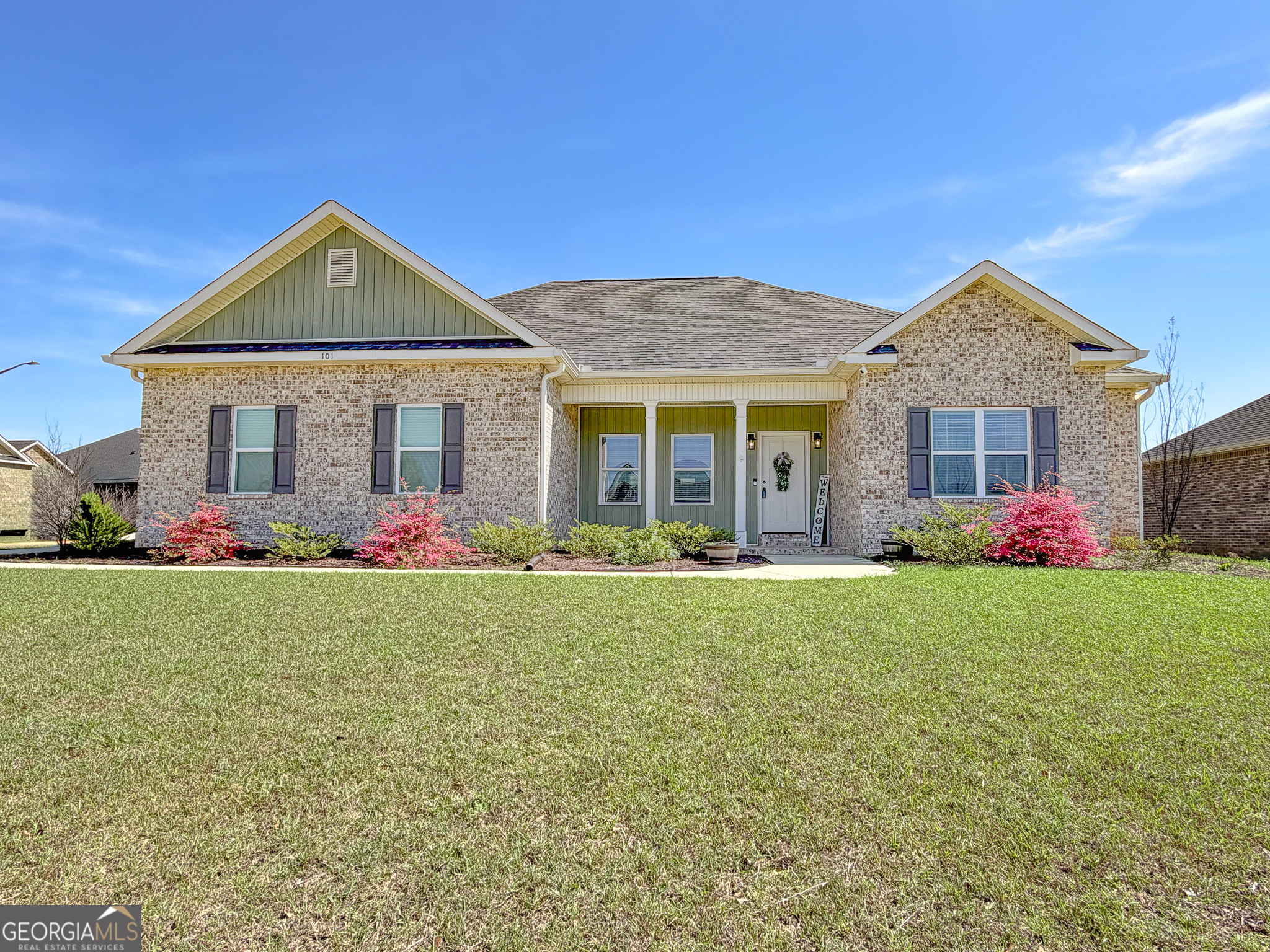 a front view of a house with a yard and garage