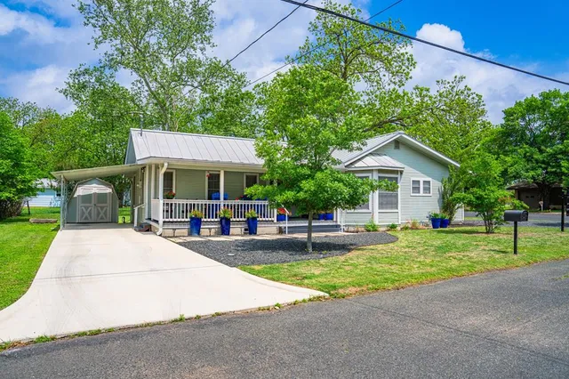 a view of a house with a yard and sitting area