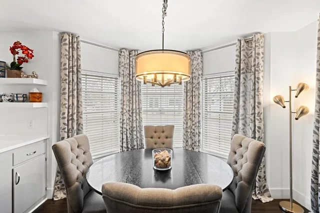 a living room with furniture a table & chairs