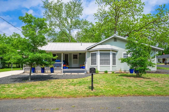 a front view of a house with a yard table and chairs