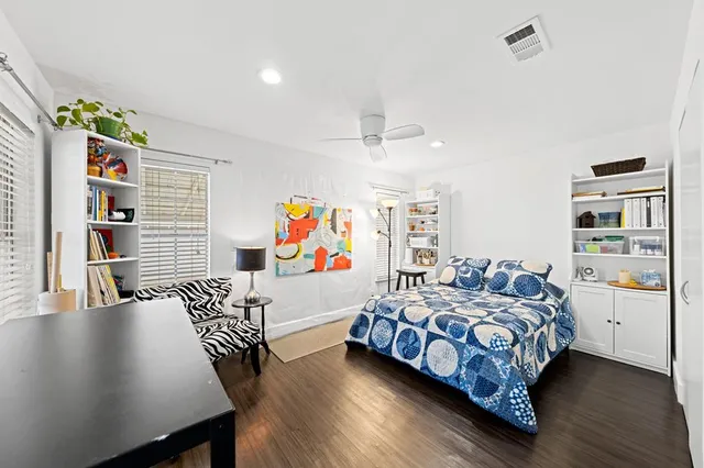 a bedroom with furniture and a book shelf