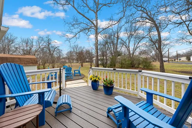 a view of a chairs and table in patio with a yard