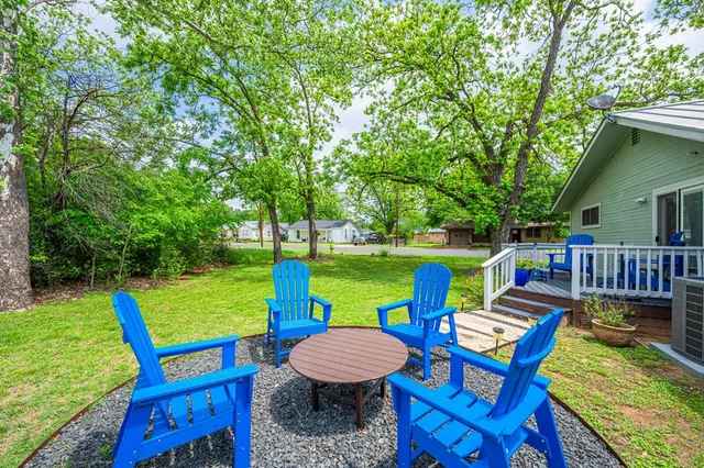 a view of a chairs and table on the deck in the patio