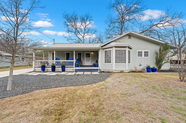 a view of a house with a swimming pool and a yard