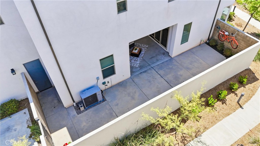 182 Scale Irvine, CA 92618 - Photo 53 of 61 Bird's eye view of the private rear yard, covered patio, dual sliders, and that orange cruiser bike hanging on the wall. Every inch is accounted for.