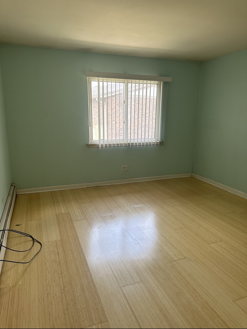 9s070 South Frontage Road, Unit 204 Willowbrook, IL 60527 - Photo 11 of 18 an empty room with wooden floor and windows