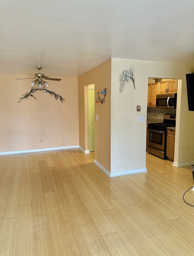 9s070 South Frontage Road, Unit 204 Willowbrook, IL 60527 - Photo 13 of 18 a view of a livingroom with a flesh screen tv and wooden floor