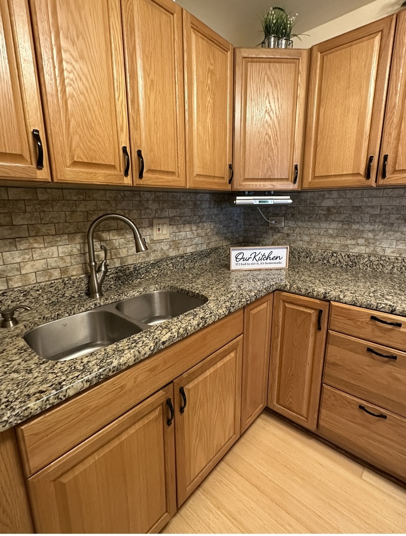 9s070 South Frontage Road, Unit 204 Willowbrook, IL 60527 - Photo 3 of 18 a kitchen with stainless steel appliances granite countertop a sink a stove and cabinets