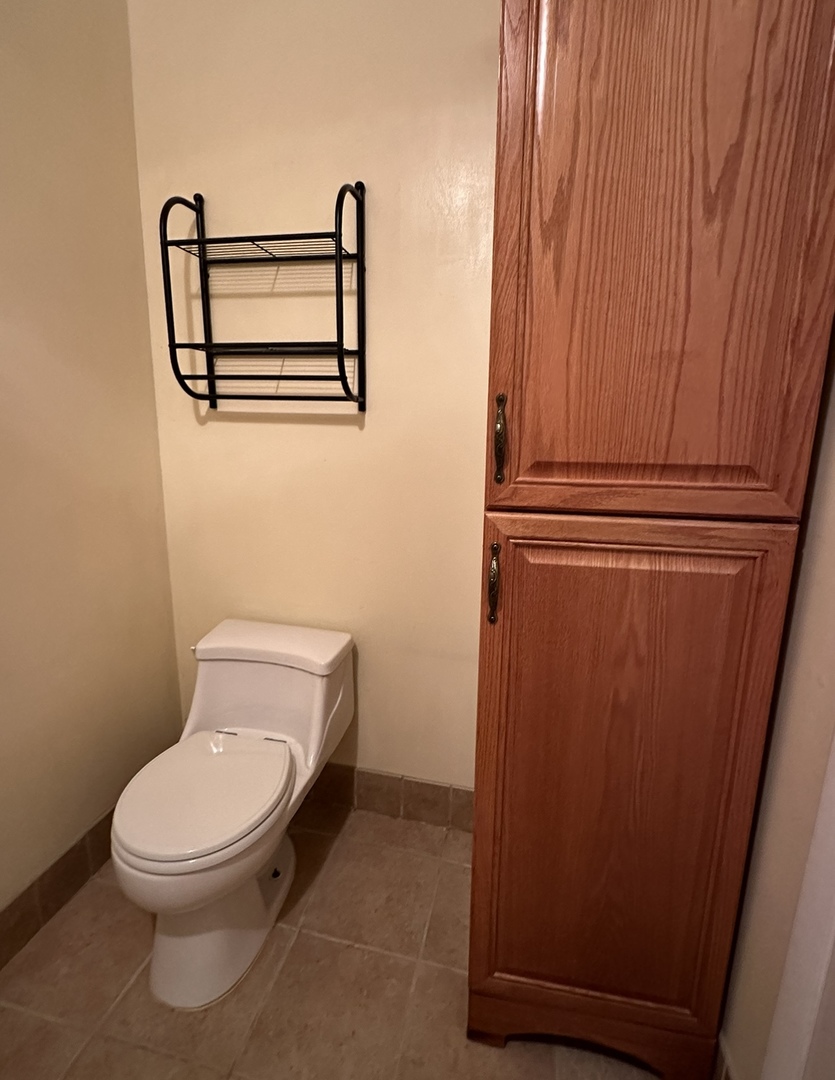 9s070 South Frontage Road, Unit 204 Willowbrook, IL 60527 - Photo 7 of 18 a white toilet sitting next to a shower