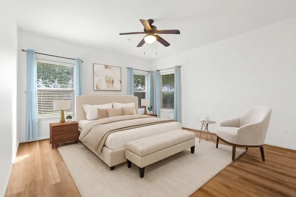 a spacious bedroom with a bed and a couch