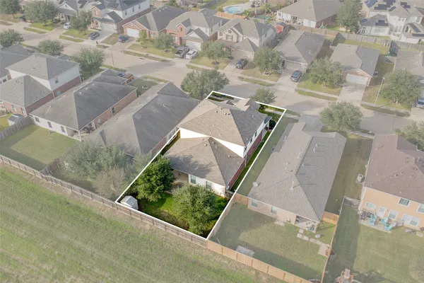 an aerial view of a house with a yard