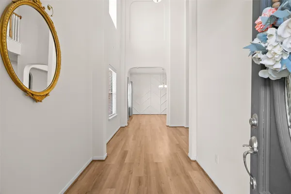 a view of a room with wooden floor and bench