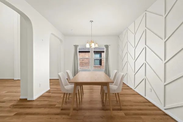 a view of a dining room with furniture and wooden floor