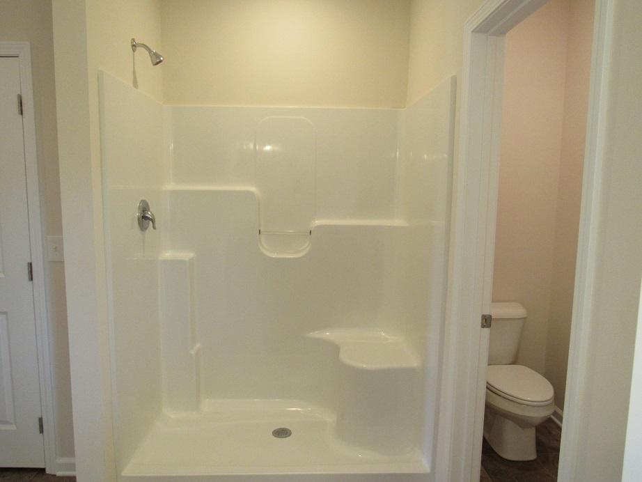 4441 Old Stage Road Radford, VA 24141 - Photo 16 of 32 a bathroom with a shower a toilet and a sink