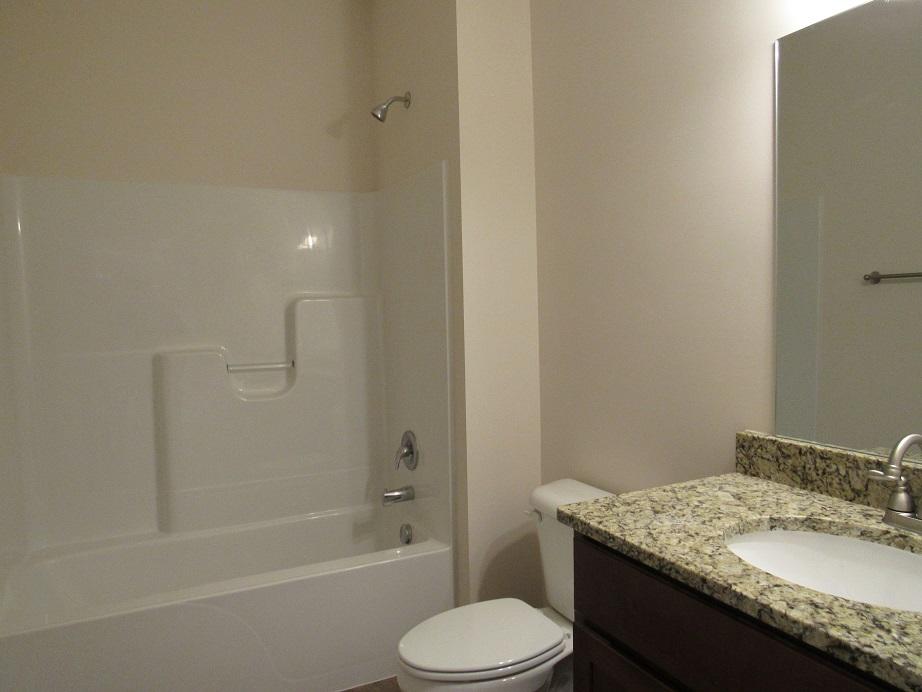 4441 Old Stage Road Radford, VA 24141 - Photo 20 of 32 a bathroom with a granite countertop sink toilet and shower
