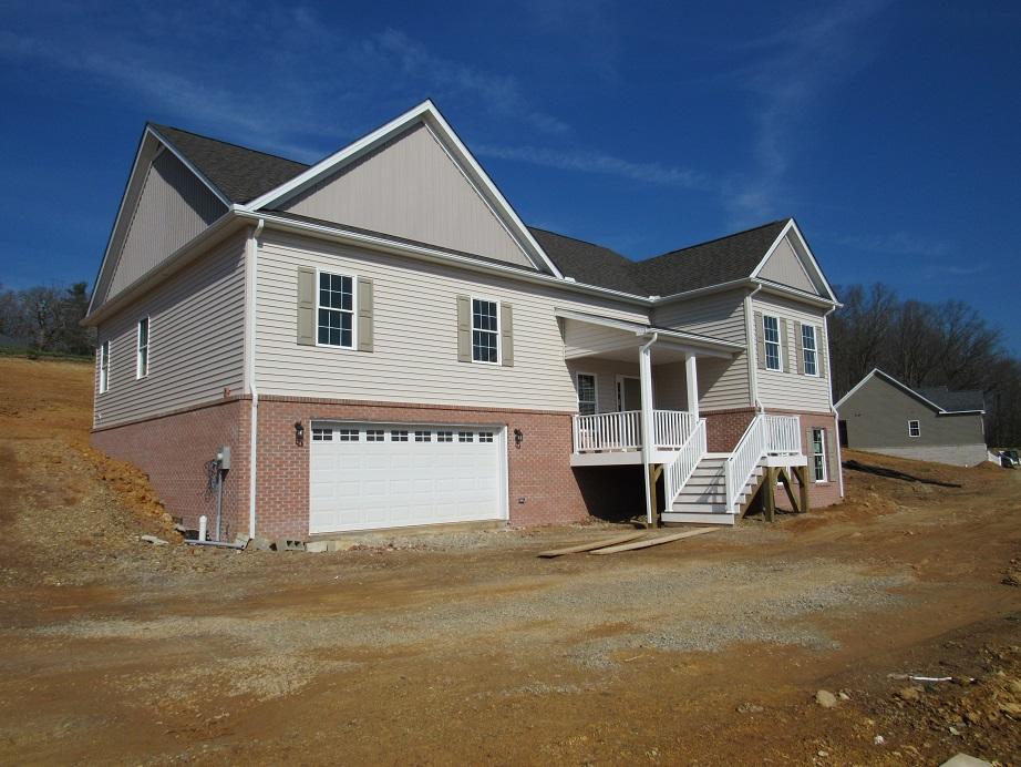 4441 Old Stage Road Radford, VA 24141 - Photo 3 of 32 a front view of a house with a yard and garage