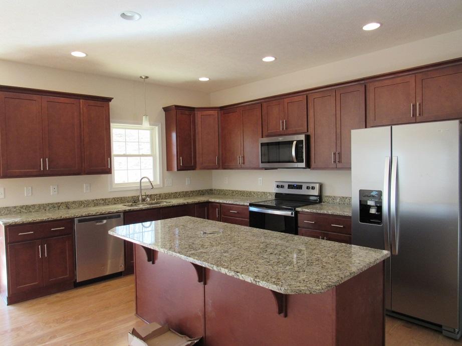 4441 Old Stage Road Radford, VA 24141 - Photo 5 of 32 a kitchen with granite countertop stainless steel appliances a sink dishwasher a refrigerator and a stove with wooden floor
