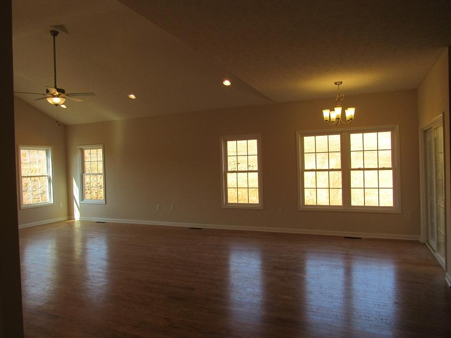 4441 Old Stage Road Radford, VA 24141 - Photo 9 of 32 an empty room with wooden floor and windows