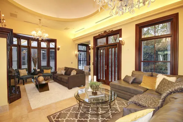 a living room with furniture a rug and a table