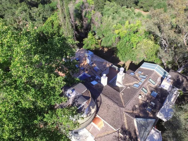 a living room with furniture and large windows