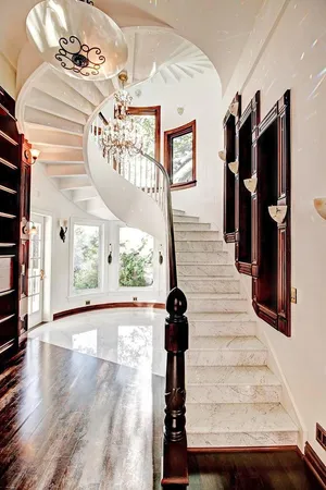 a view of a hallway with furniture and floor to ceiling window