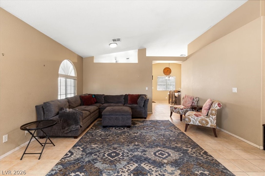 2377 Ramsgate Drive Henderson, NV 89074 - Photo 6 of 25 Natural light pours into this living space with its unique arched window and soaring ceilings.