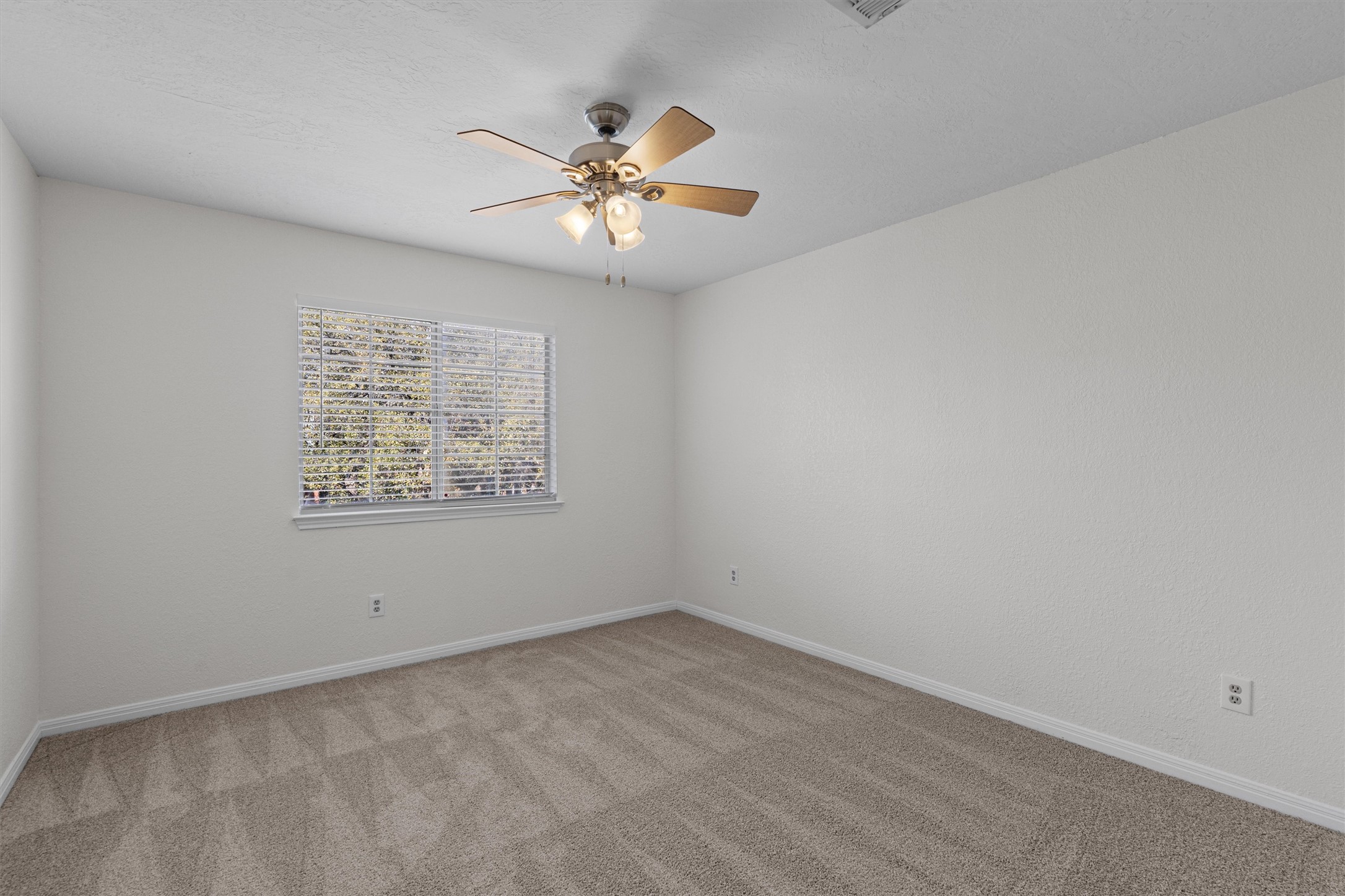 10506 Walpole Lane Austin, TX 78739 - Photo 32 of 40 Unfurnished room featuring light colored carpet and a ceiling fan