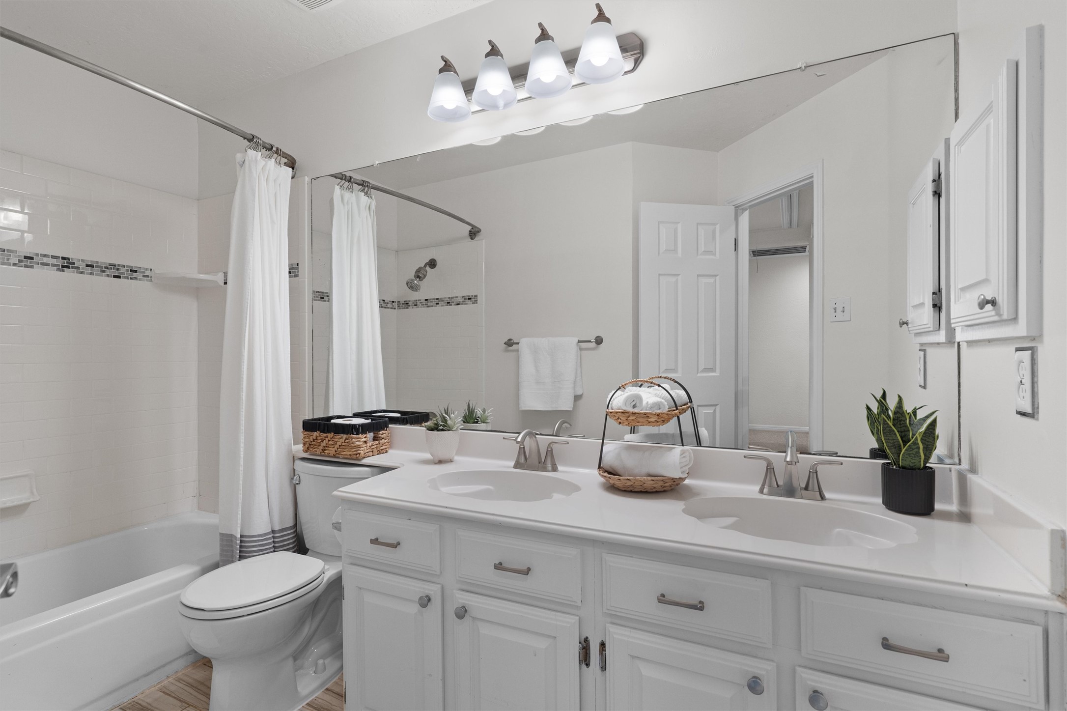 10506 Walpole Lane Austin, TX 78739 - Photo 36 of 40 Bathroom with shower / bathtub combination with curtain, double vanity, and light wood-style flooring