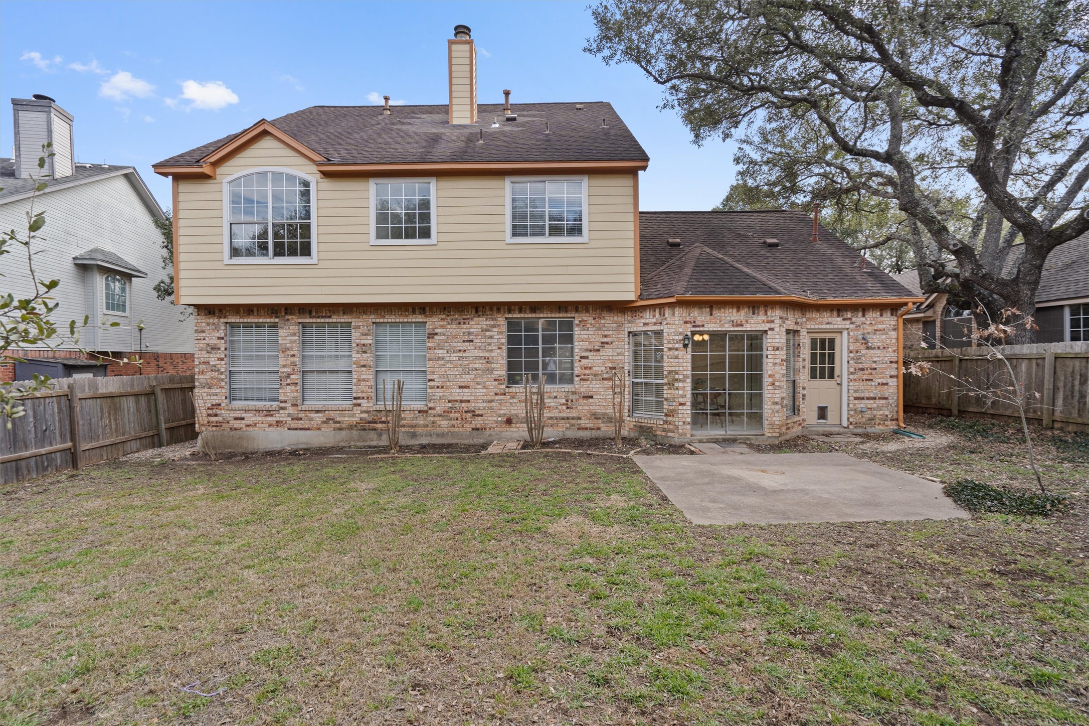 10506 Walpole Lane Austin, TX 78739 - Photo 39 of 40 Back of property with a patio area, a fenced backyard, brick siding, and roof with shingles
