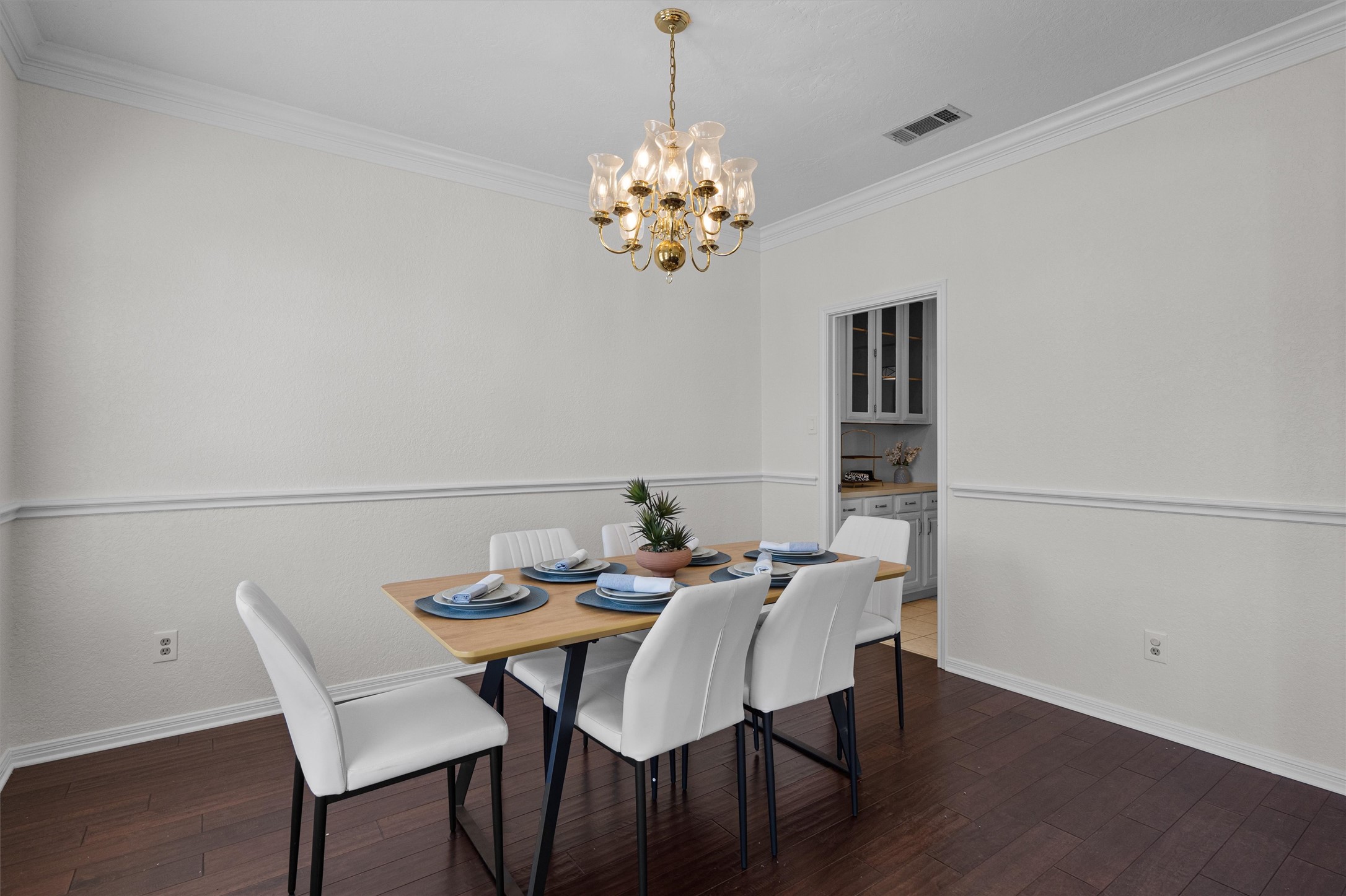 10506 Walpole Lane Austin, TX 78739 - Photo 7 of 40 Dining space featuring crown molding, a chandelier, and dark wood-type flooring