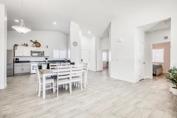 a view of a dining room with furniture and a rug