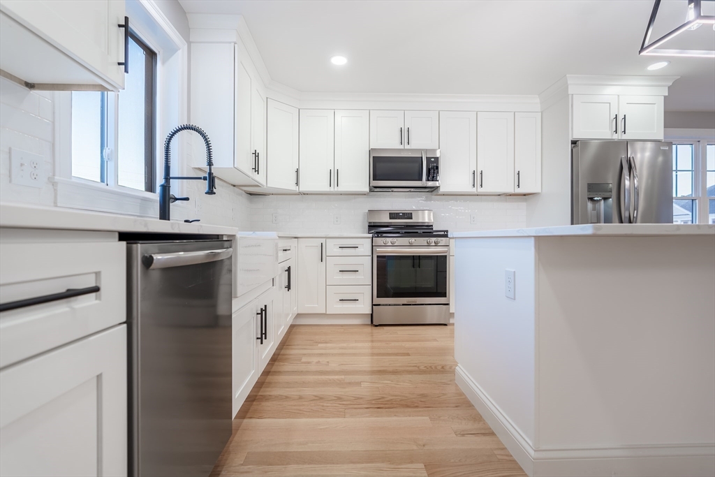 214 Horton Street Fall River, MA 02723 - Photo 15 of 40 a kitchen with stainless steel appliances granite countertop a stove top oven a sink and dishwasher
